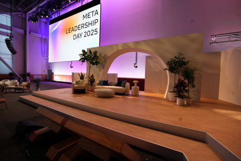 Meta Leadership Day 2025 main stage with branded screens, curved white lounge seating, and purple ambient lighting