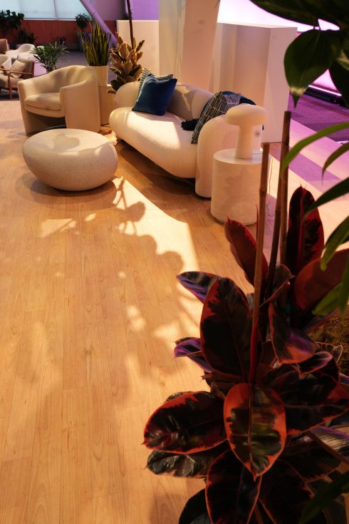 Meta Leadership Day 2025 lounge area with curved white seating, blue pillows, plants, and natural sunlight