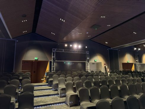 Microsoft Spear 2025 theater with tiered seating, professional truss lighting system, and acoustic ceiling design