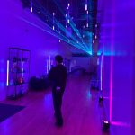 Polychain Investor Day 2025 entrance with immersive purple and blue LED lighting design and ceiling installation