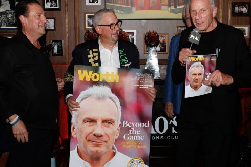 Joe Montana speaking at Rao's Crucial Catch to Intercept Cancer event with NFL Super Bowl LX banner and guests