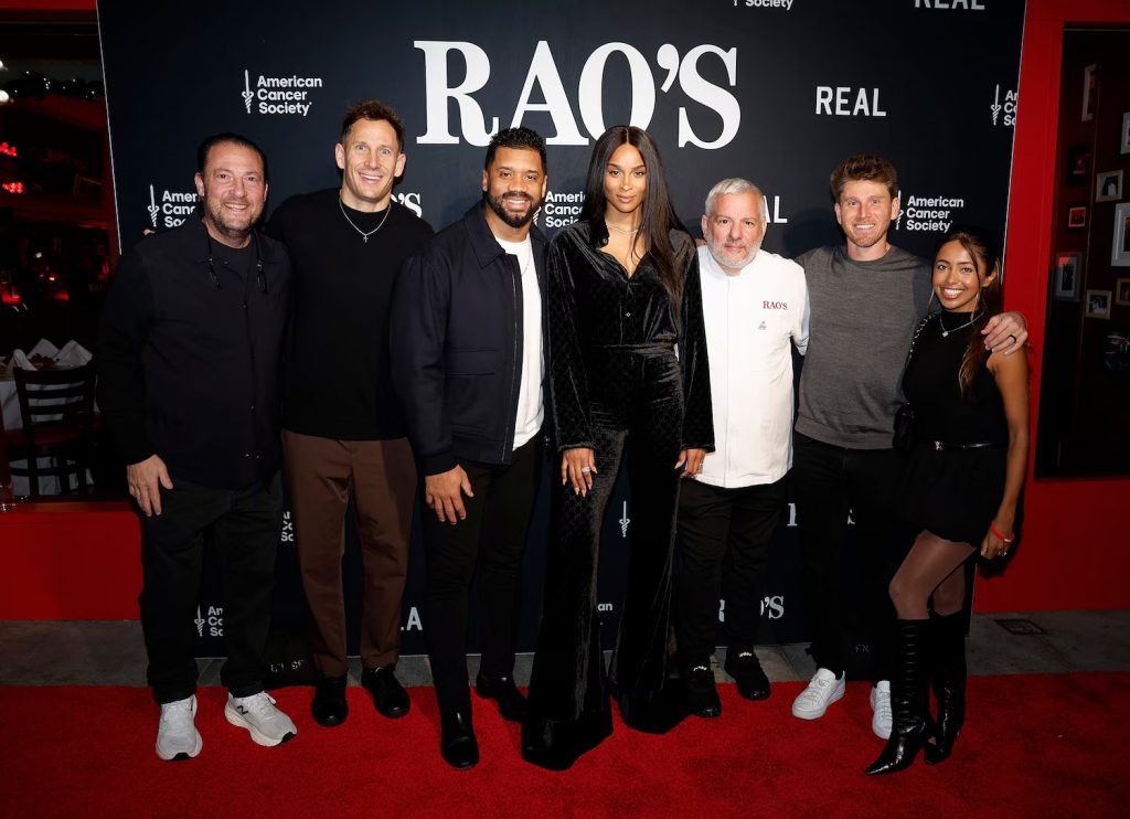 Group photo on red carpet at Rao's Crucial Catch event with American Cancer Society and REAL branding step and repeat