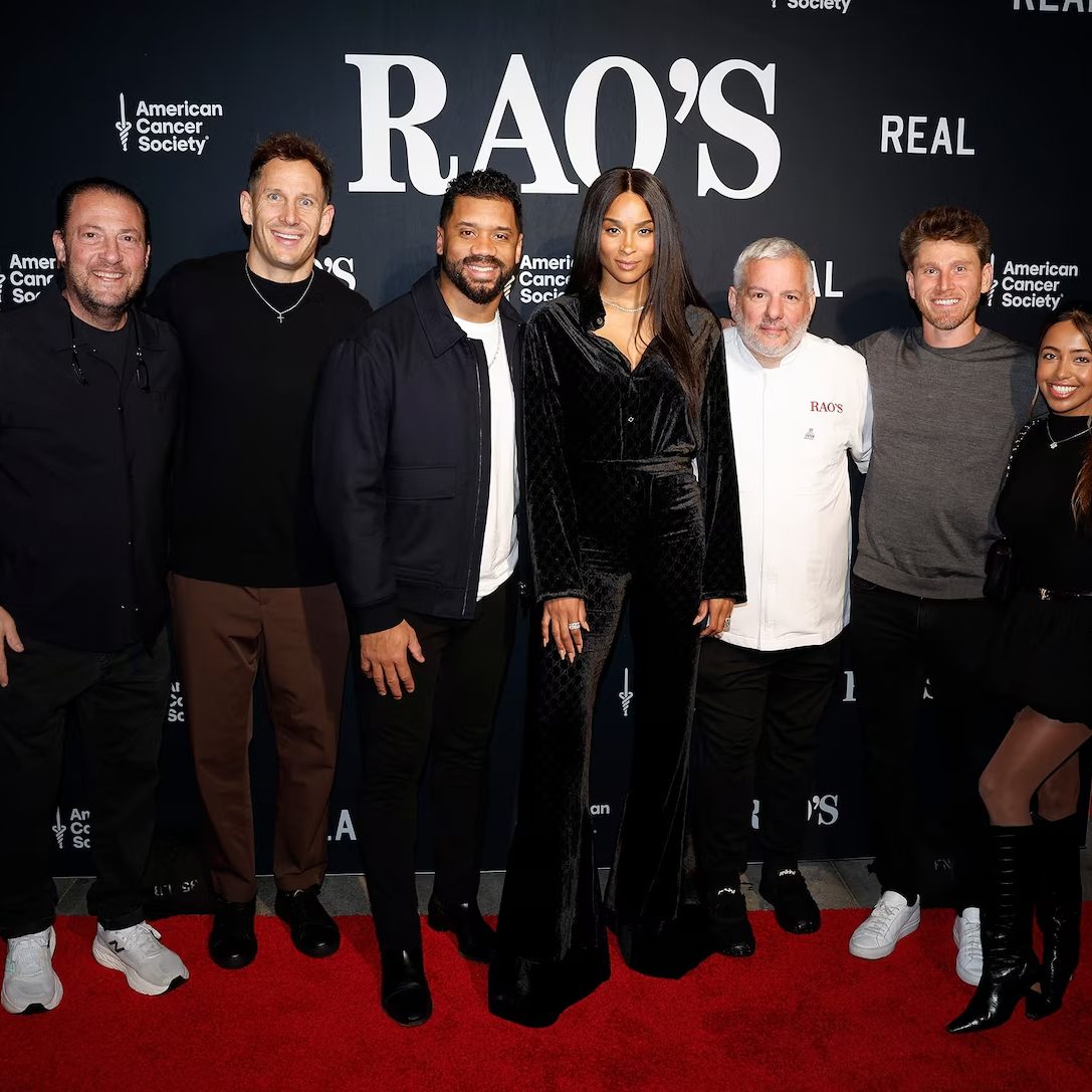 Group photo on red carpet at Rao's Crucial Catch event with American Cancer Society and REAL branding step and repeat